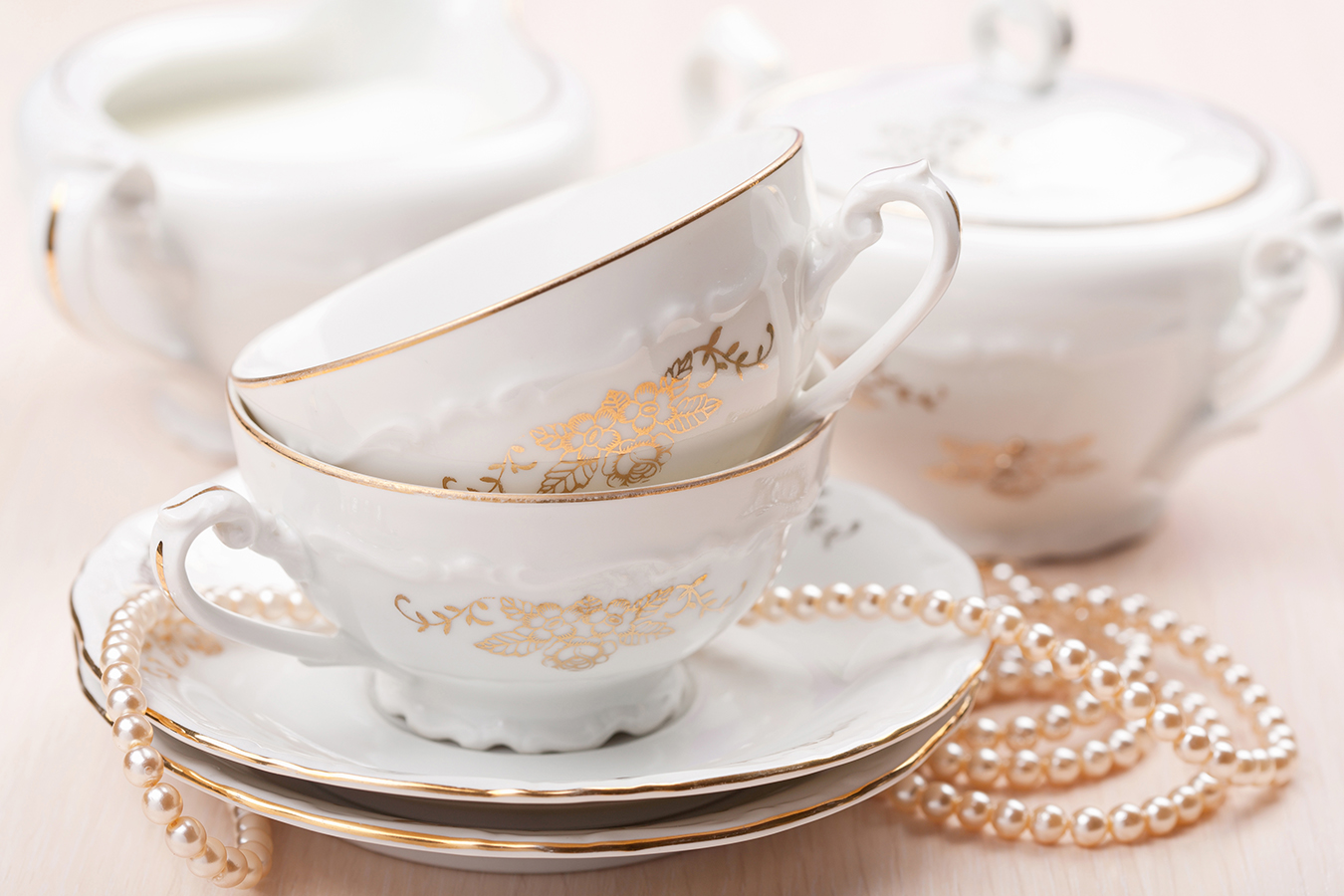 antique teacups and pearl necklace